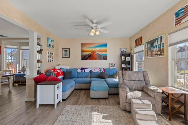 a living room with furniture and wooden floor