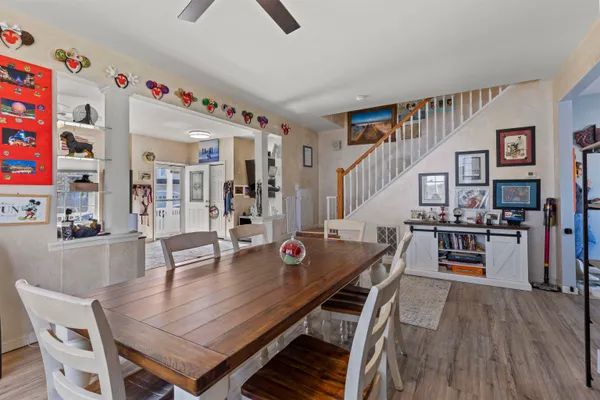a dining room with furniture and wooden floor