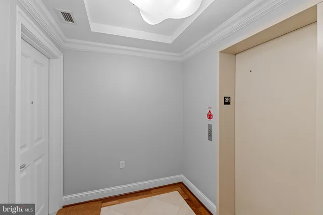 a small space with wooden floor and a window