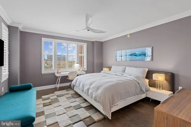 a bedroom with a bed wooden floor and window