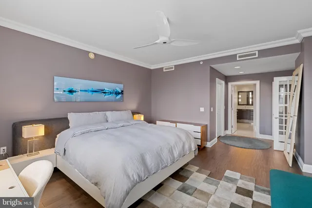 a bedroom with a large bed and a chandelier