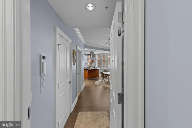 a view of a hallway with wooden shelves