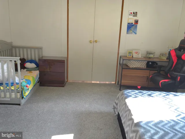 a bedroom with a bed and a desk