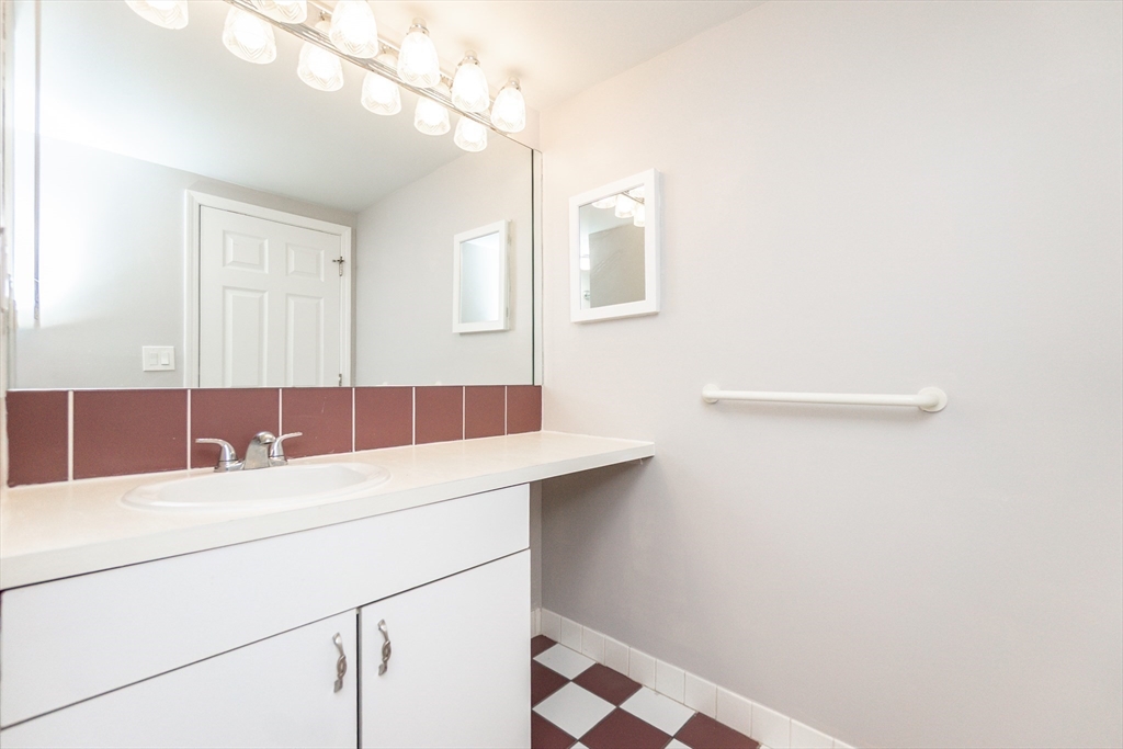 1933 Commonwealth Avenue, Unit 108 Boston, MA 02135 - Photo 21 of 27 a bathroom with a sink and a mirror