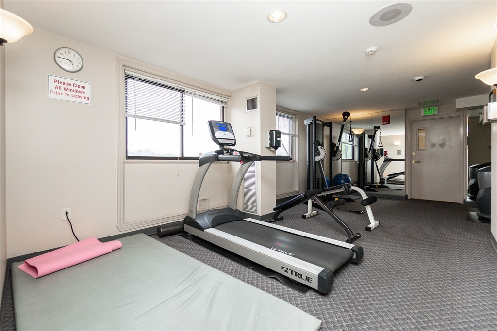 1933 Commonwealth Avenue, Unit 108 Boston, MA 02135 - Photo 25 of 27 a room with gym equipment and a large window