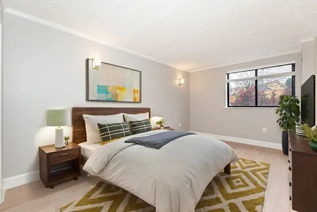 a bedroom with a bed and a potted plant