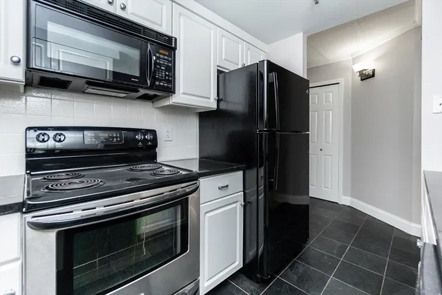 a kitchen with stainless steel appliances a stove a microwave and cabinets