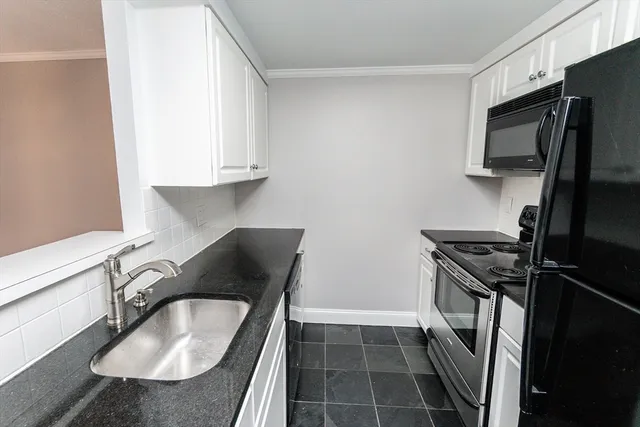a kitchen with a sink stove and refrigerator