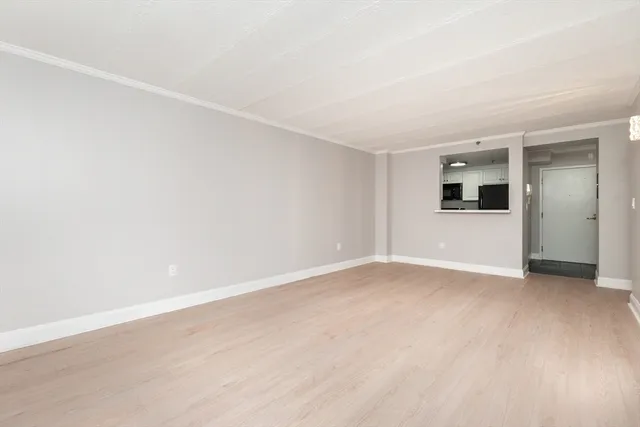 an empty room with a kitchen