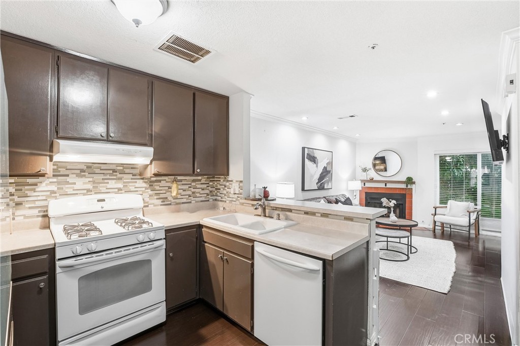 334 South Walnut Avenue, Unit D Brea, CA 92821 - Photo 11 of 32 a kitchen with a sink stove and cabinets