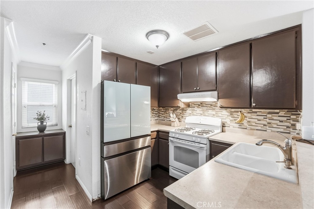 334 South Walnut Avenue, Unit D Brea, CA 92821 - Photo 13 of 32 a kitchen with a sink stainless steel appliances and cabinets