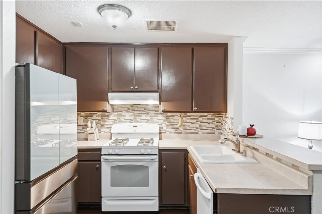 334 South Walnut Avenue, Unit D Brea, CA 92821 - Photo 14 of 32 a kitchen with a sink stove and refrigerator