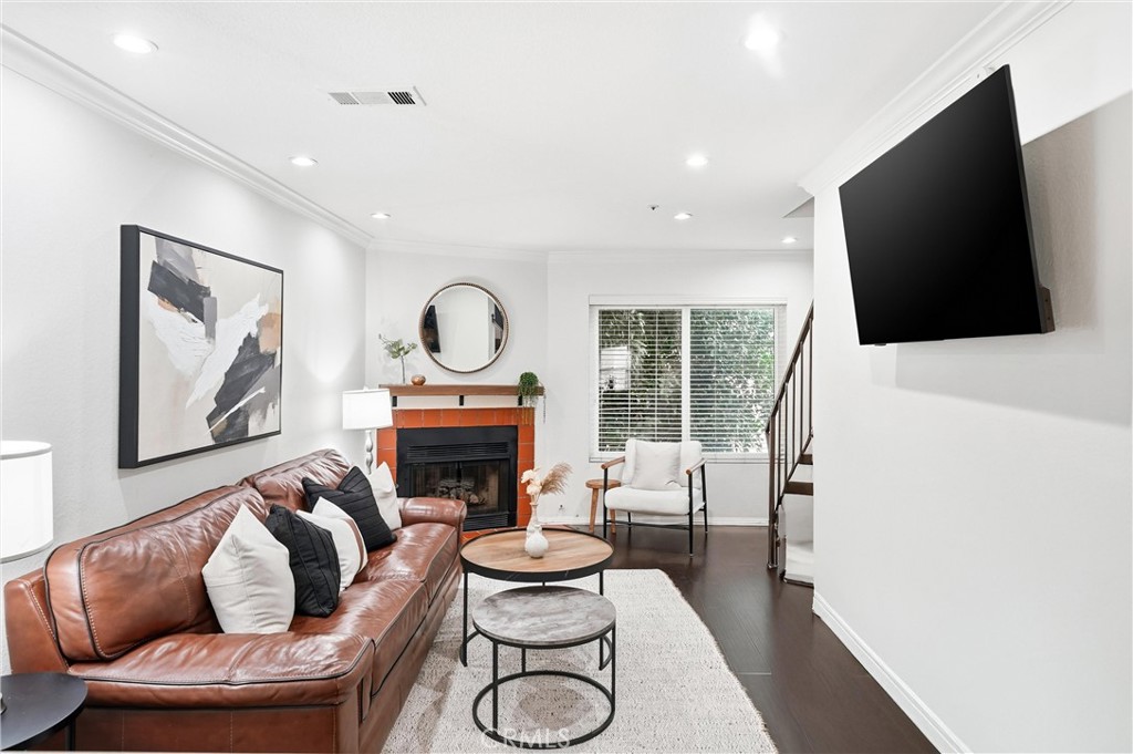 334 South Walnut Avenue, Unit D Brea, CA 92821 - Photo 9 of 32 a living room with furniture a flat screen tv and a fireplace