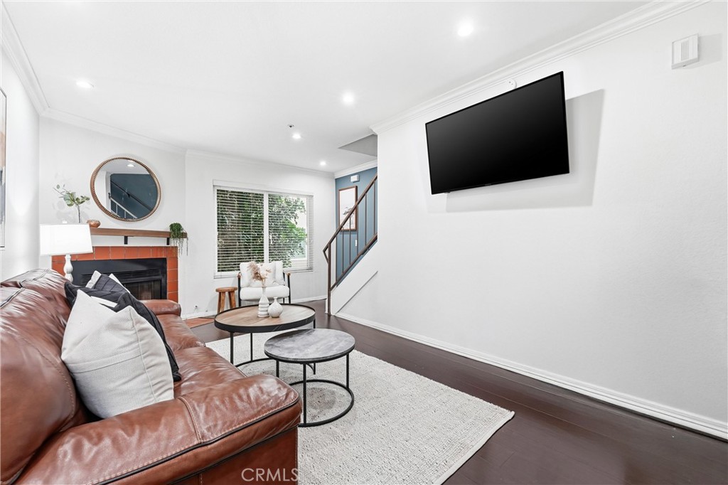 334 South Walnut Avenue, Unit D Brea, CA 92821 - Photo 10 of 32 a living room with furniture a fireplace and a flat screen tv
