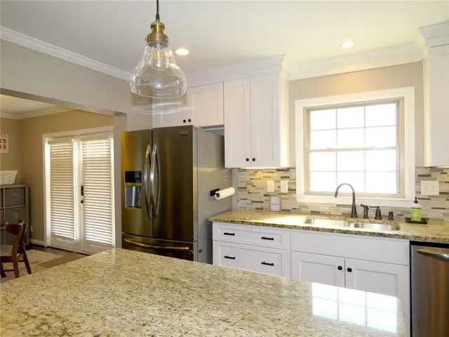 a view of a dining room with furniture and a window