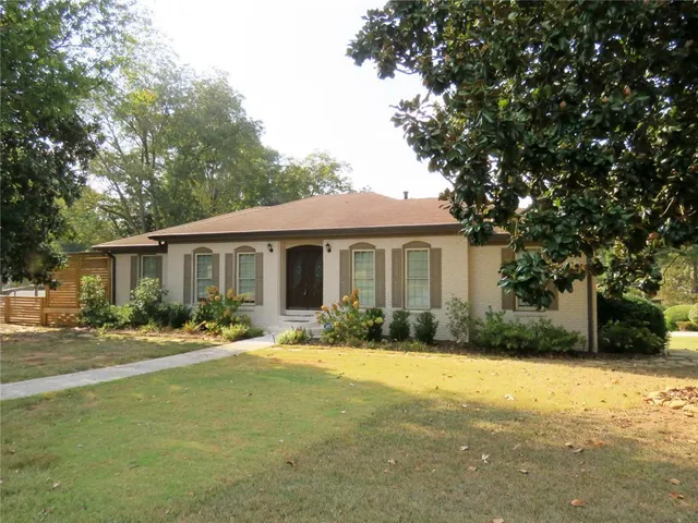 a view of a backyard with table and chairs under an umbrella