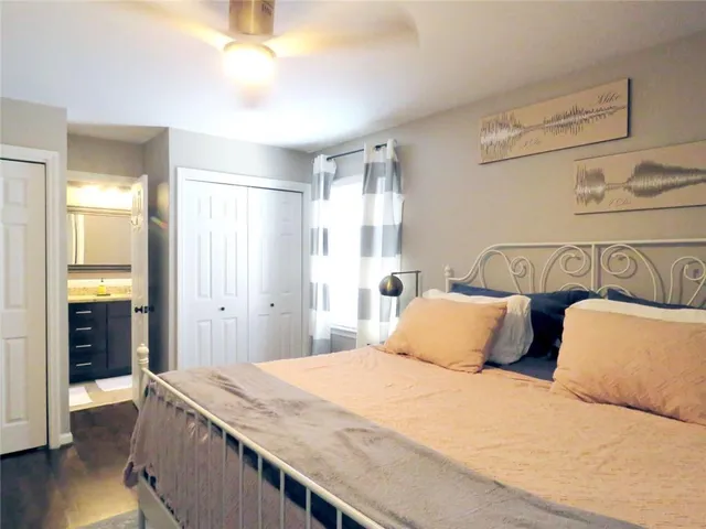 a view of a hallway with wooden floor and furniture