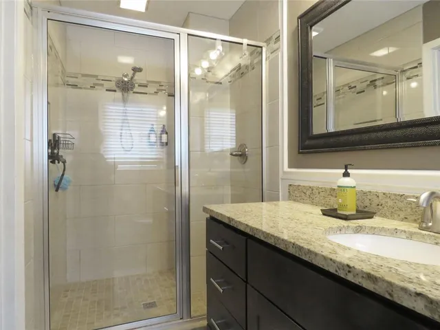 a view of a patio with table and chairs with wooden floor and fence