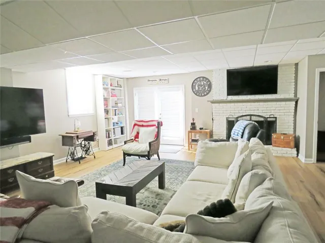 a view of a roof deck with couches and a fire pit