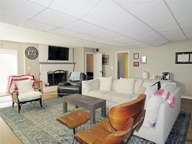 a view of house with yard and sitting area