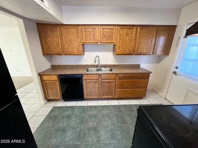 a kitchen with wooden cabinets and a sink