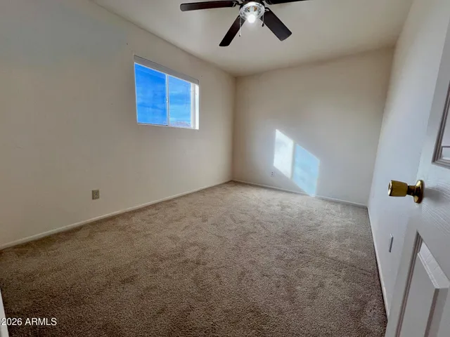 a view of a livingroom with a ceiling fan and window