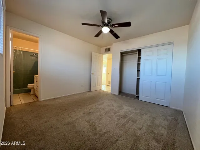 a view of a livingroom with a ceiling fan and window