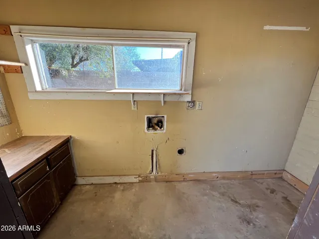a view of room with window and cabinet