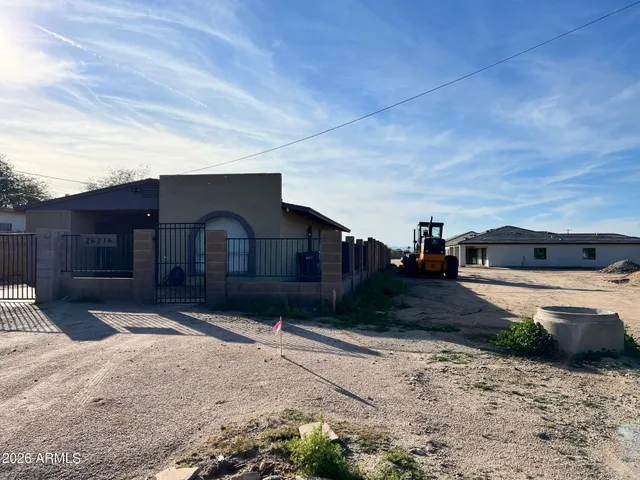 a wooden bench sitting in front of a house