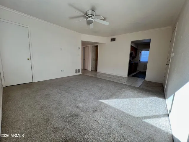 a view of an empty room with a ceiling fan