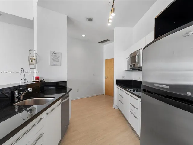 a kitchen that has a sink and a stove