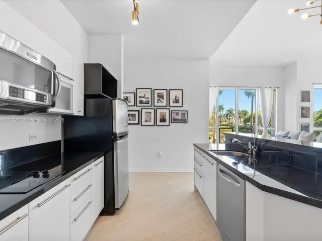 a kitchen with stainless steel appliances granite countertop a sink and a stove