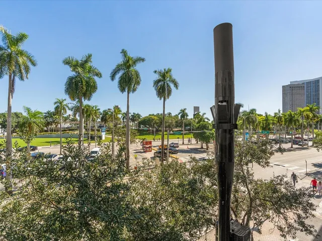a view of a lake with a tree and a yard