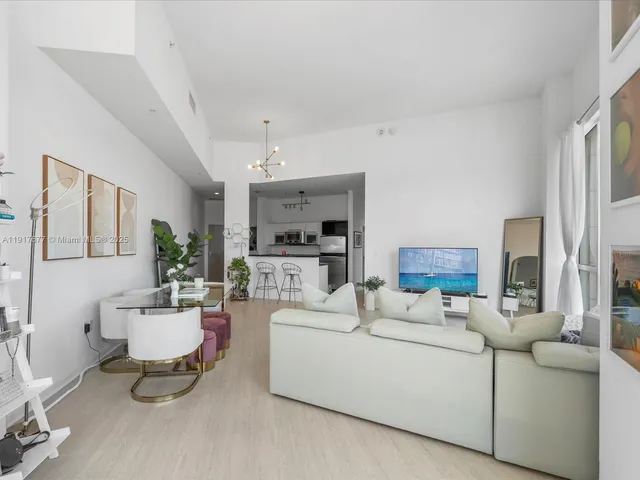 a living room with furniture and a mirror