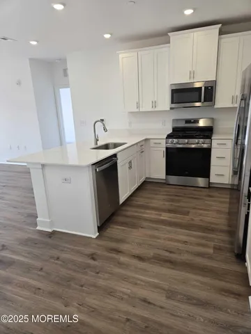 a kitchen with granite countertop a stove and a sink