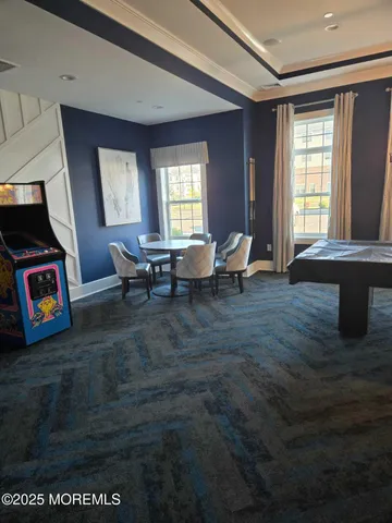 a view of a big room with dining table and chairs