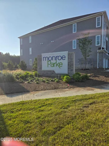 a view of a brick house with a yard