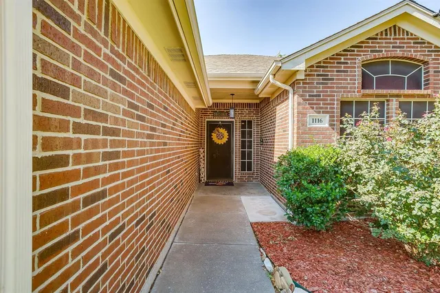 a view of a brick house with many windows