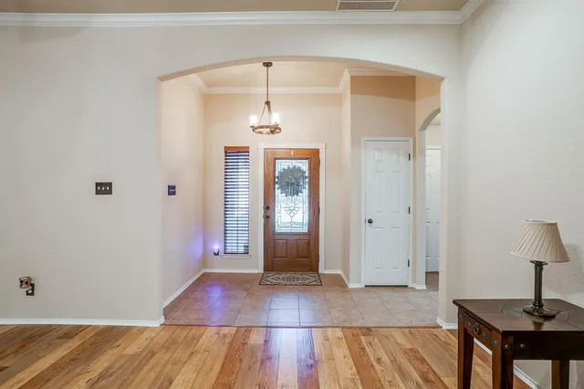 a view of a room with wooden floor and cabinet