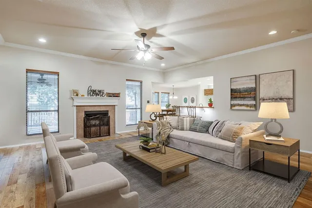 a living room with furniture a fireplace and a window