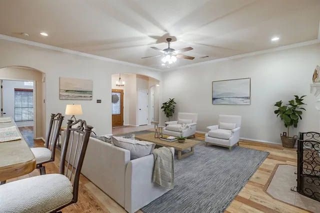 a living room with furniture chess table and a potted plant