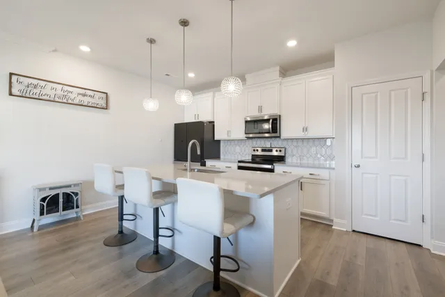 a living room with furniture wooden floor and a window