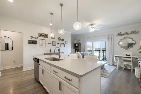 a living room with furniture and kitchen view