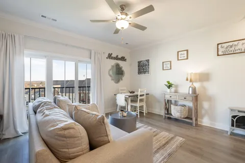 a spacious bedroom with a bed and a chandelier