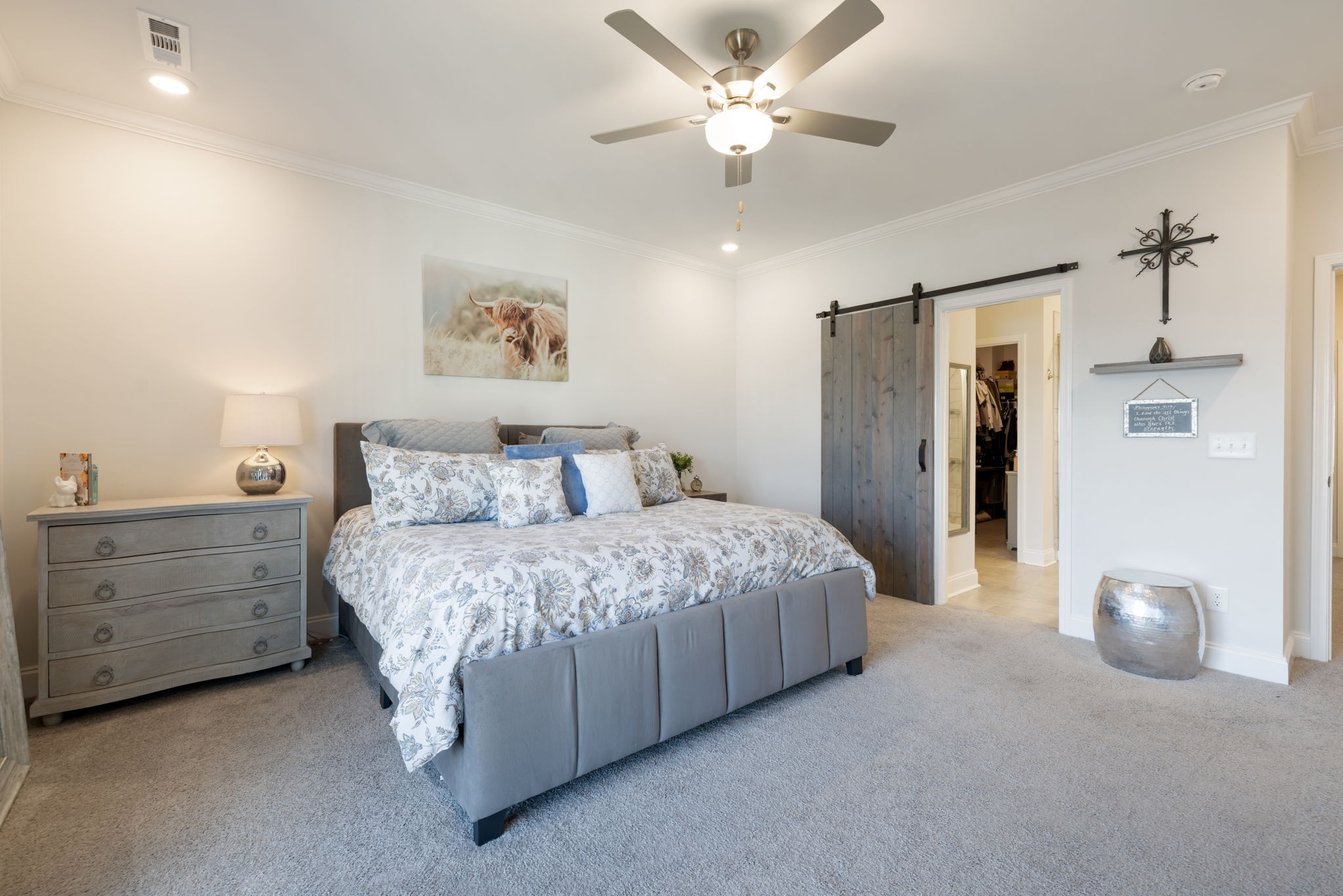4018 Orsman Lane Antioch, TN 37013 - Photo 30 of 75 a spacious bedroom with a bed and a chandelier