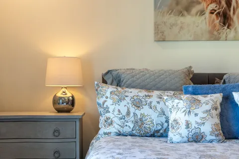 a bedroom with bed and a large window