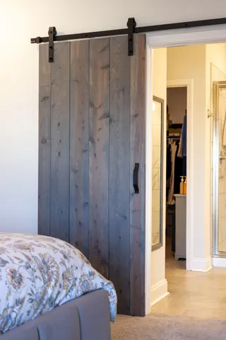 a bedroom with a bed and a chandelier