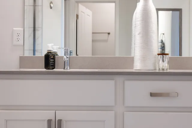 a bathroom with a sink double vanity and a mirror