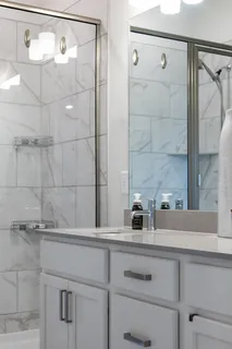 a kitchen with white cabinets and sink