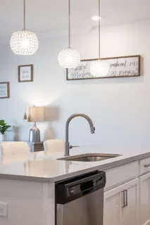 a kitchen with kitchen island white cabinets and stainless steel appliances